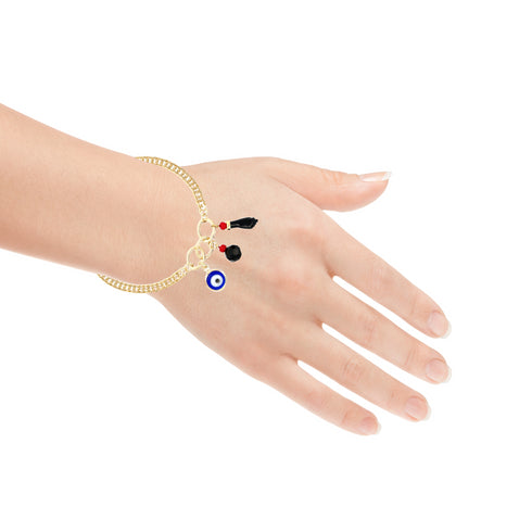 A hand is shown wearing the "Blue Evil Eye Figa Hand Curb Chain with 3 Lucky Charms" bracelet, featuring a gold chain design and adorned with a blue and white evil eye charm, small black and red tassels, and an Azabache charm for extra protection, all against a white background.